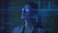 The businesswoman standing near the blue screen 4k or 4k+ Resolution