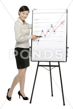 Businesswoman standing by whiteboard Stock Photos