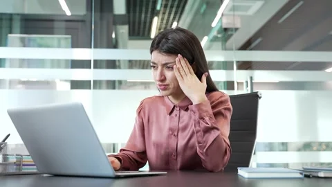 Businesswoman suffering from headache while working on laptop in office, Видео 332848331