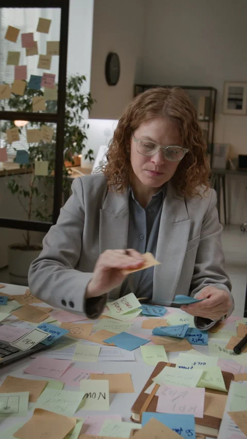 Businesswoman Surrounding Workspace With Task Notes Stock Footage 330487568