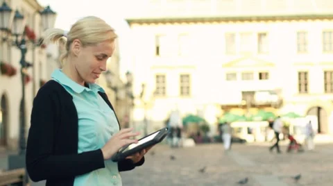 Businesswoman with tablet computer in the city, steadycam shot Stock Footage