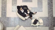Businesswoman Takes Suitcase And Goes To Reception Desk In A Hotel Stock Footage