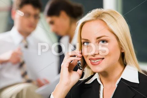 Businesswoman is talking to her cell-phone discussing important questions Stock Photos