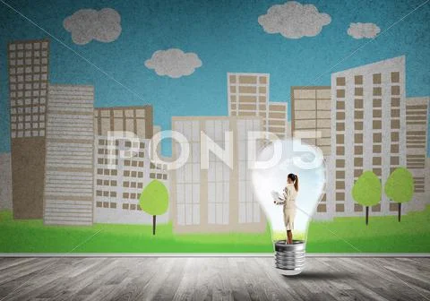 Businesswoman trapped in bulb Stock Photos