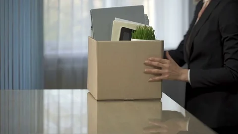 Businesswoman unpacking stuff from box onto her new office desk, employment Stock Footage