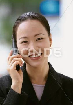 Businesswoman Using Cell Phone, Smiling At Camera, Portrait