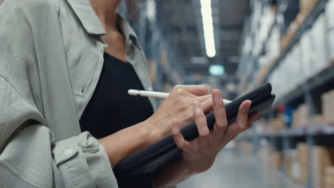 Businesswoman using digital tablet checking inventory levels in shopping center. Stock Footage 148678432