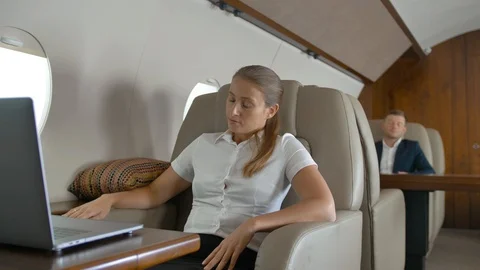 Businesswoman using laptop computer on business private jet board Stock Footage