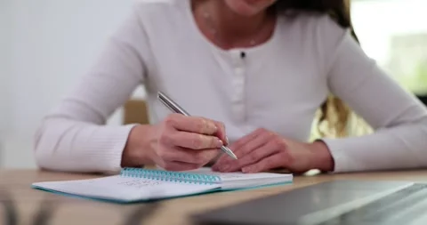 Businesswoman using laptop to write notes at desk in office Video stock 255100579