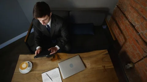Businesswoman using tablet computer in cafe on wood table. top view Stock Footage 90296090