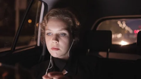 Businesswoman Using a Tablet Computer in the Moving Car Stock Footage 81117041