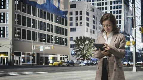 Businesswoman using tablet to solve work tasks in downtown center Stock Photos