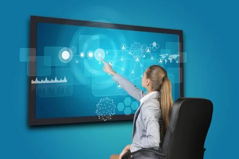 Businesswoman using touch screen interface Stock Photos