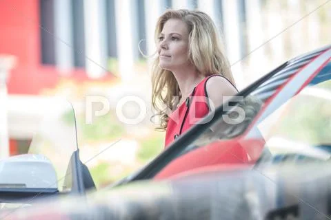 Businesswoman Waiting Next To Car In City