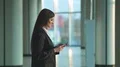 The businesswoman walk and phone in the business center. Slow motion 4k or 4k+ Resolution