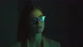 The businesswoman walking in the dark room near a display. slow motion 4k or 4k+ Resolution