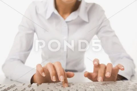 Businesswoman in white shirt doing some computer work Stock Photos