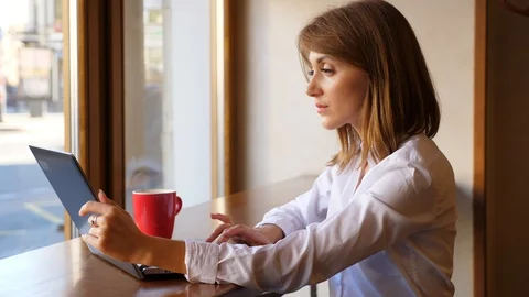 Businesswoman work on notebook computer in cafe Stock Footage 95742397