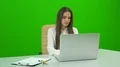 The businesswoman working at the desktop on the green background 4k or 4k+ Resolution