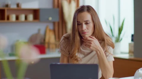 Businesswoman working on laptop computer at home. Woman using laptop on kitchen Stock Footage