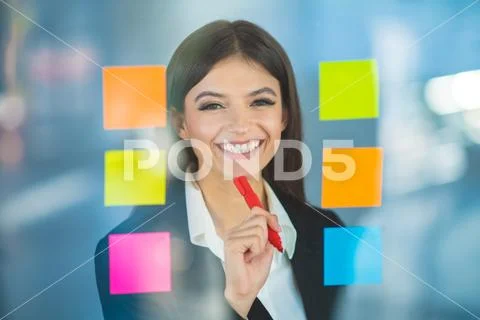 The businesswoman writing a note on the sticker Stock Photos