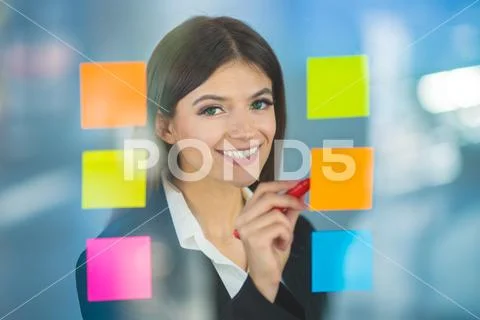 The businesswoman writing a note on the sticker Stock Photos