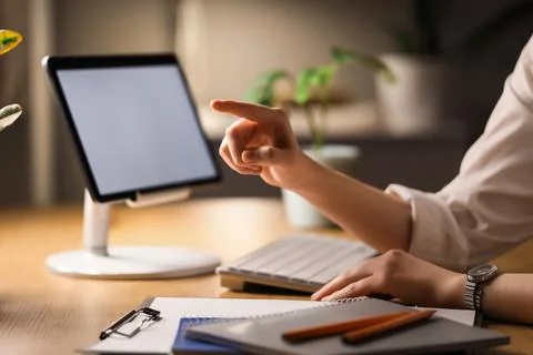 Businesswoman's hands with tablet computer using virtual screen in office at  Stock Photos