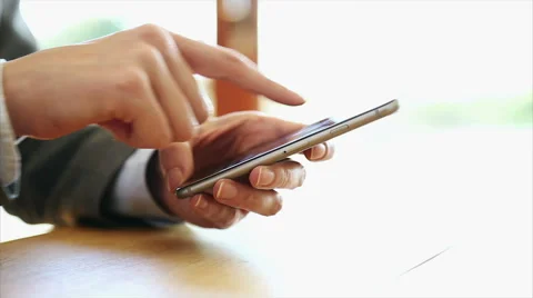 Businesswoman's hands using smart phone at desk Stock Footage 53484231