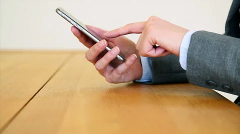 Businesswoman's hands using smart phone at desk Stock Footage 53487614