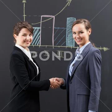 Businesswomen shaking hands Stock Photos