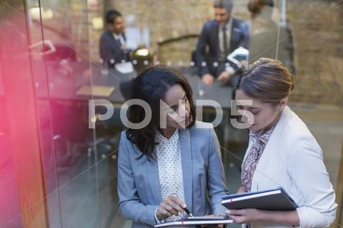 Businesswomen Talking Outside Conference Room Meeting
