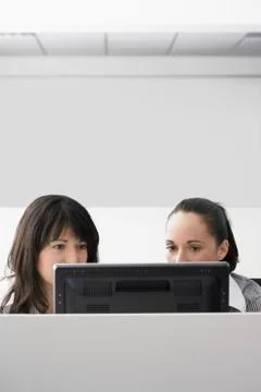 Businesswomen Using Computer In Cubicle Stock Photos