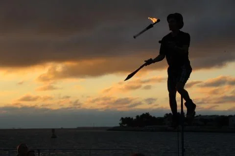 Busker and sunset (fire, juggle, unicycle!) Stock Photos
