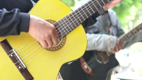 Busker group of men playing guitar music instrument to entertain people. Stock Footage 295422061