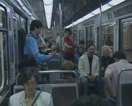 Busker inside subway train playing music Stock Footage 8916191