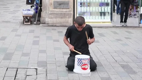 A busker playing drum using bucket in the istiklal street Video stock 245331908