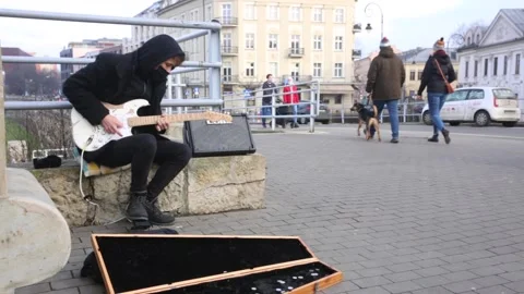 Busker playing electric guitar in the street. 4328 Stock Footage
