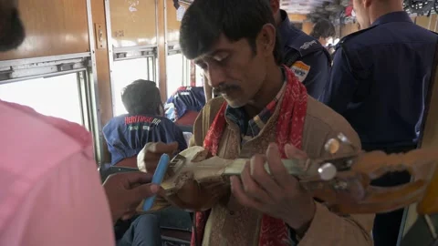 A busker playing music on a train Stock Footage 153123612