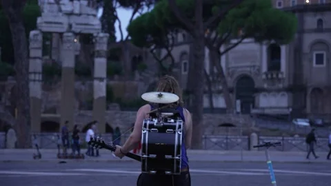 Busker on the street of Rome playing multiple instrument. Stock Footage 220952769