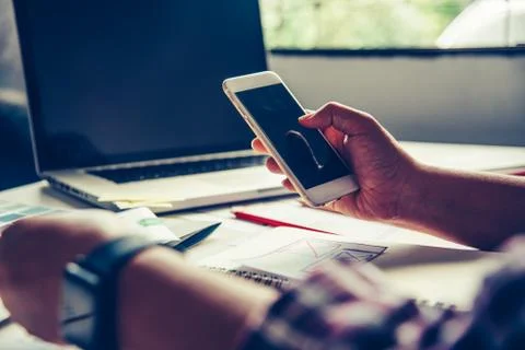 Bussinessman are using their mobile to work with a laptop Stock Photos