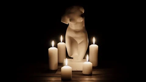 Bust of Venus and burning candles on a black background 動画素材 101419031