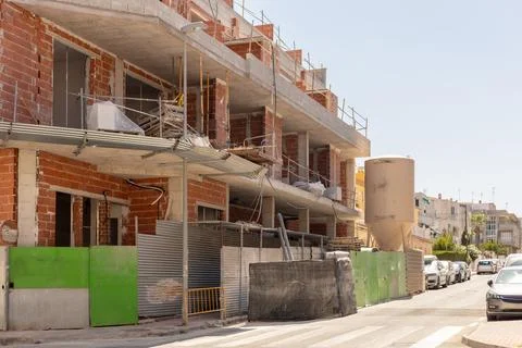 Bustling activity of construction site, showcasing multiple levels of unfinished Stock Photos