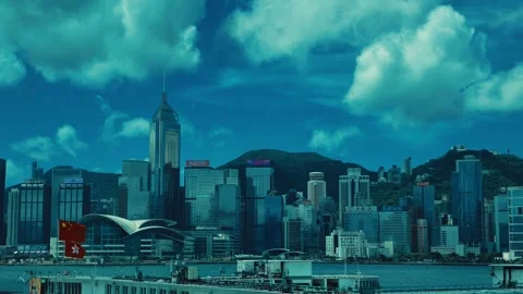 A bustling cityscape featuring modern high-rise buildings, lush green hills, and Stock Footage 338310984