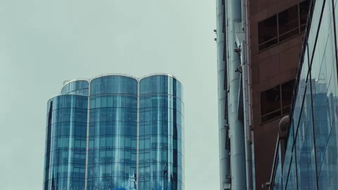 A bustling cityscape featuring towering skyscrapers and cylindrical towers in Video stock 338311515