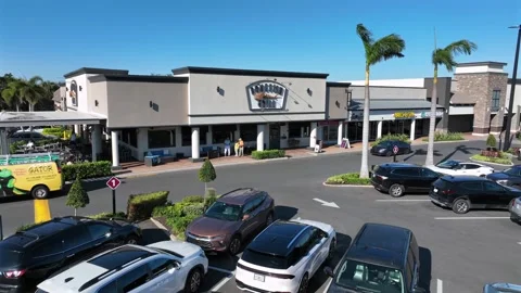 Bustling commercial area with bonefish grill restaurant in a sunny town Stock Footage 304501680