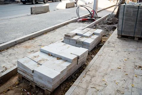 A bustling construction site that features large piles of bricks along with.. Stock Photos