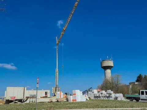 A bustling construction site featuring a large crane and an elevated water .. Stock Photos