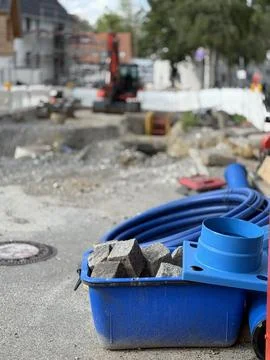 A bustling construction site with tools and equipment, surrounded by urban Stock Photos