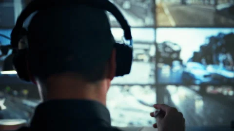 In a bustling control center a traffic analyst monitors screens evaluating v Stock Footage 336570415