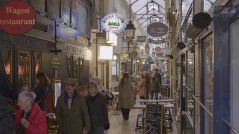 Bustling covered passage in Paris filled with people, vintage shops and Stock Footage 305642293